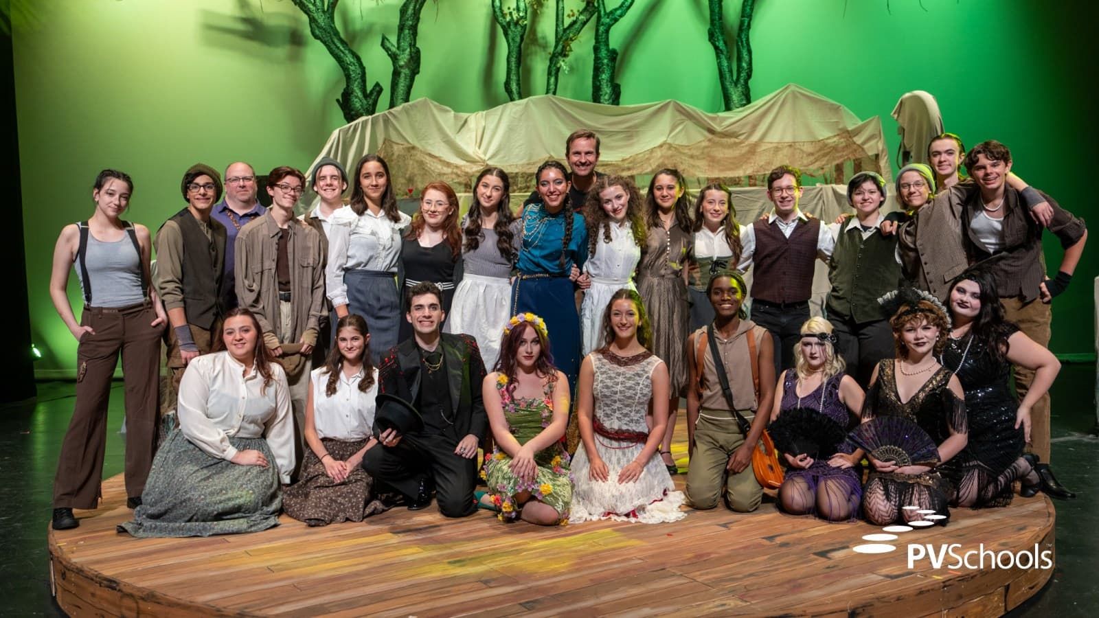 Hadestown ensemble performing under stage lights